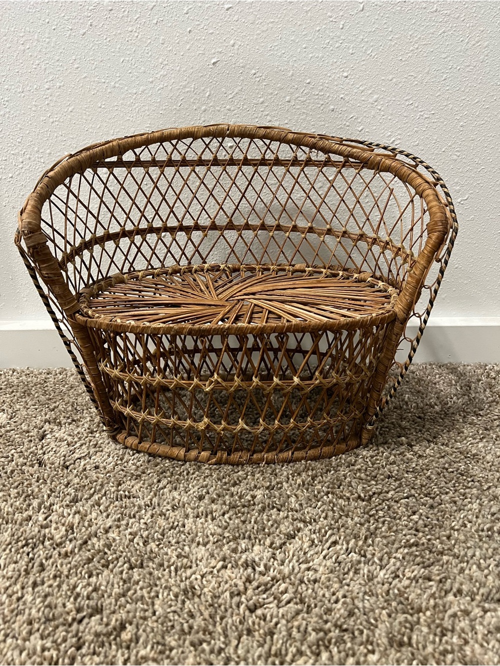 Vintage miniature wicker peacock chair features intricate woven rattan 1970s